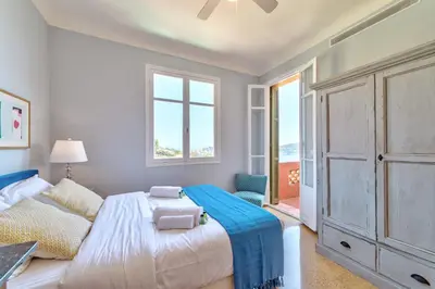 a bedroom with a bed and a window at Villa Francesca Beautiful villa with sea view and swimming pool! in Villefranche-sur-Mer