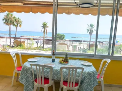 a table with chairs and a table with a view of the ocean at Horizon in Saint-Laurent-du-Var