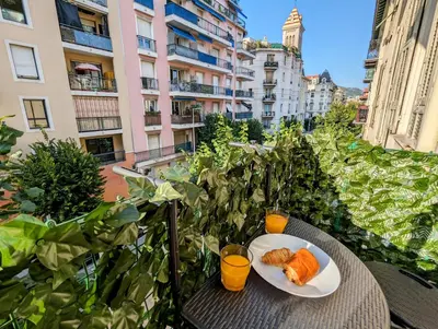 a plate of food on a table on a balcony at Cozy T2 - Lovely Balcony - Center - Liberation - Clim - WIFI in Nice
