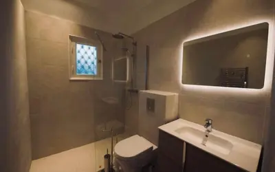 a bathroom with a toilet and a sink and a mirror at Villa prestigieuse avec piscine privée au cœur de Nice in Nice