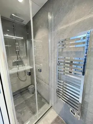 a shower with a glass door in a bathroom at Beach front, Superbe appartement pour 4 personnes in Nice