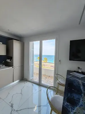 a kitchen with a view of the ocean at Beach front, Superbe appartement pour 4 personnes in Nice