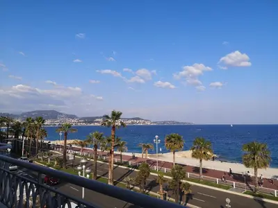 a view of the beach and the ocean from a balcony at Beach front, Superbe appartement pour 4 personnes in Nice