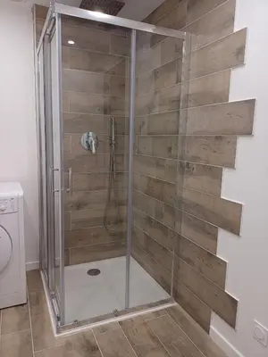 a shower with a glass door in a bathroom at Joli 3p - Bas de villa in Saint-Andre-de-la-Roche