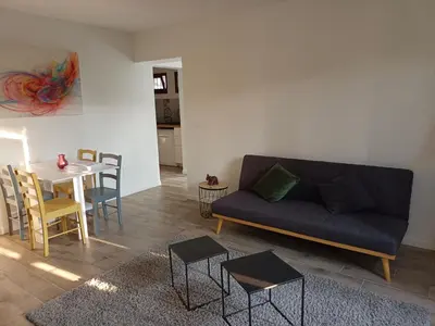 a living room with a couch and a table at Joli 3p - Bas de villa in Saint-Andre-de-la-Roche