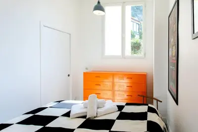 a bedroom with a black and white checkered bed at L50 2P Rauba Capeu SEA View IloveNice Balcony&AC in Nice