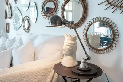 a lamp on a table next to a bed with a mirror at L50 2P Rauba Capeu SEA View IloveNice Balcony&AC in Nice