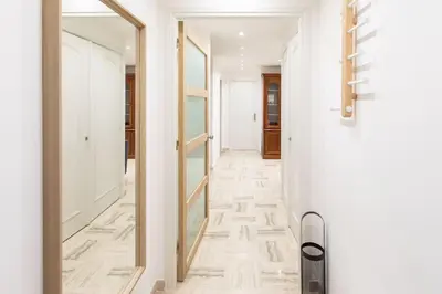 a hallway with white walls and a mirror at L43 Suite Maurice sea view 6Pax/Terrace,Parking,AC in Saint-Laurent-du-Var