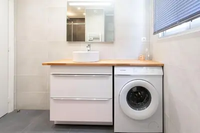 a bathroom with a washing machine and a sink at L43 Suite Maurice sea view 6Pax/Terrace,Parking,AC in Saint-Laurent-du-Var