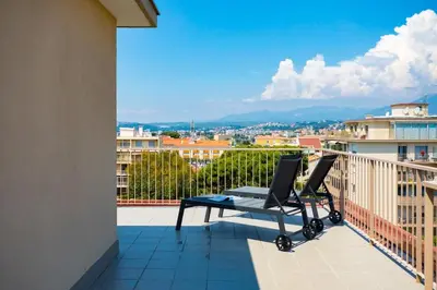 a balcony with a table and chairs on a balcony at L43 Suite Maurice sea view 6Pax/Terrace,Parking,AC in Saint-Laurent-du-Var