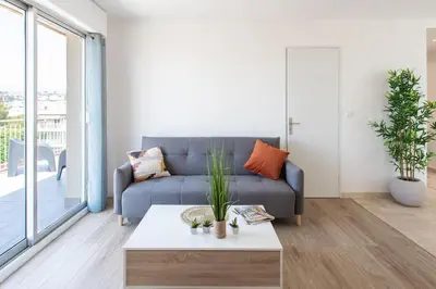 a living room with a couch and a coffee table at L43 Suite Maurice sea view 6Pax/Terrace,Parking,AC in Saint-Laurent-du-Var