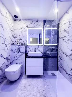 a white bathroom with a sink and a toilet at Promenade-des-anglais-front-sea in Nice