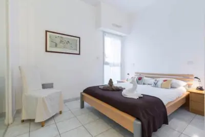 a bedroom with a bed with a table and a chair at St JEAN CAP FERRAT CENTRAL CONTEMPORARY LOVELY WIFI in Saint-Jean-Cap-Ferrat