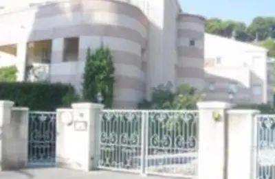 a white fence in front of a building at St JEAN CAP FERRAT CENTRAL CONTEMPORARY LOVELY WIFI in Saint-Jean-Cap-Ferrat