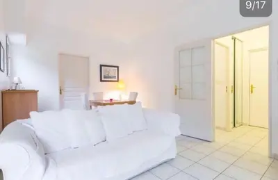 a white living room with a white couch and a table at St JEAN CAP FERRAT CENTRAL CONTEMPORARY LOVELY WIFI in Saint-Jean-Cap-Ferrat