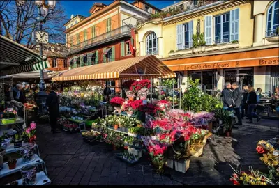 a group of people walking around a market with flowers at Studio 2 steps from the sea near the Negresco hotel in Nice
