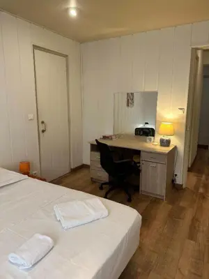 a room with two beds and a desk with a computer at MY CASA - BOSIO RAOUL - Central few steps to the sea in Nice