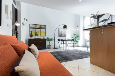 a living room with an orange couch and a table at MY CASA - MASSENA 2 - Great location Massena Square with AC in Nice