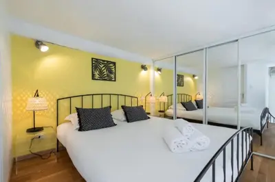 a bedroom with a large white bed with mirrors at MY CASA - MASSENA 2 - Great location Massena Square with AC in Nice