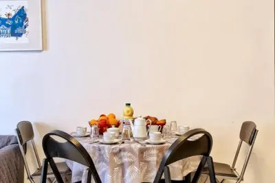 a table with a table cloth with fruit on it at Superbe Appartement Près de la Gare-Clim-Wifi-Espace dedié au Travail in Nice