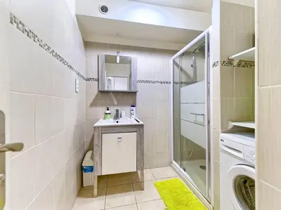 a bathroom with a sink and a washing machine at Superbe Appartement Près de la Gare-Clim-Wifi-Espace dedié au Travail in Nice