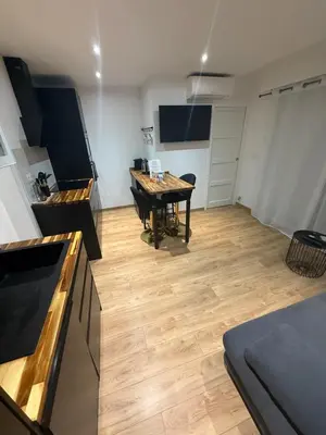 a kitchen with a table in the middle of a room at Papillon de cimiez in Nice