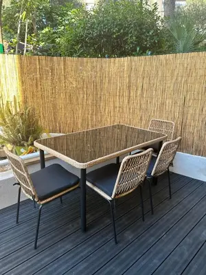 a glass table and two chairs on a deck at Papillon de cimiez in Nice