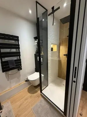 a bathroom with a toilet and a glass shower at Papillon de cimiez in Nice