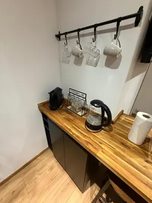 a kitchen counter with a wooden counter top with jars at Papillon de cimiez in Nice