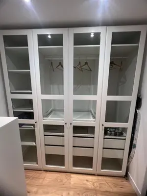 a white closet with glass doors in a room at Papillon de cimiez in Nice