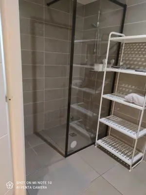 a shower with a glass door next to a bathroom at Villa Angela in Nice