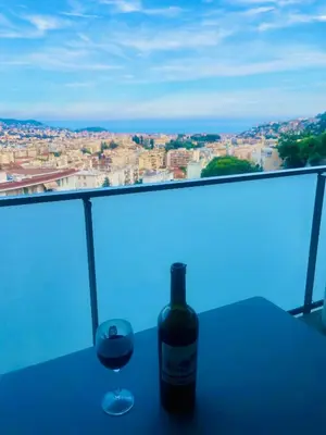 a bottle of wine and a glass on a table at Villa Angela in Nice