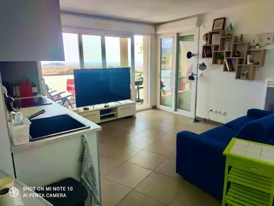 a living room with a blue couch and a television at Villa Angela in Nice