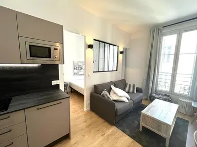a living room with a couch and a tv at Hypercentre lamartine 404 in Nice