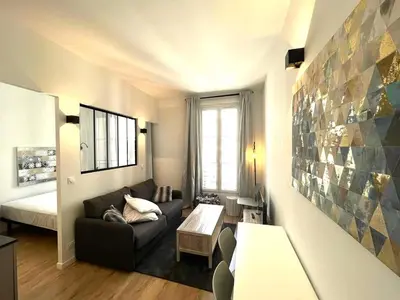 a living room with a couch and a bed at Hypercentre lamartine 404 in Nice