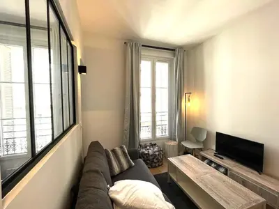 a living room with a couch and a large window at Hypercentre lamartine 404 in Nice