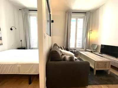 a living room with a bed and a couch at Hypercentre lamartine 404 in Nice