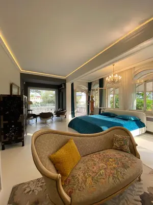 a large bedroom with a blue bed and a couch at Villa avec piscine, Nice Centre in Nice