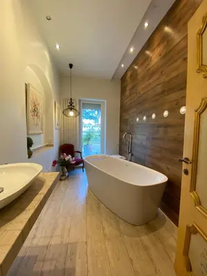 a large bathroom with a large tub and wooden wall at Villa avec piscine, Nice Centre in Nice
