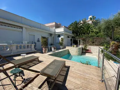 a backyard with a wooden deck and a swimming pool at Villa avec piscine, Nice Centre in Nice