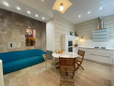 a living room with a blue couch and a table at Villa avec piscine, Nice Centre in Nice