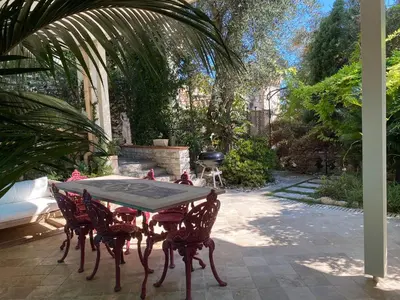 a table and chairs sitting on a patio at Villa avec piscine, Nice Centre in Nice