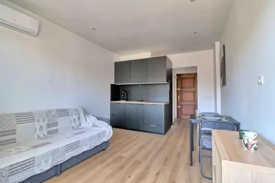 a bedroom with a bed and a table and a kitchen at Accès direct Promenade Des Anglais - Negresco in Nice