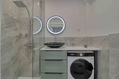a bathroom with a washing machine and a sink at Accès direct Promenade Des Anglais - Negresco in Nice