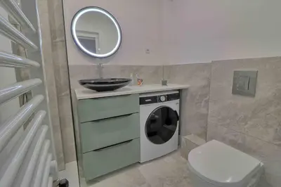 a bathroom with a washing machine and a sink at Accès direct Promenade Des Anglais - Negresco in Nice