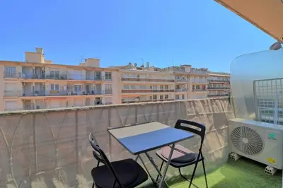 a table and chairs on a balcony with a building at Accès direct Promenade Des Anglais - Negresco in Nice