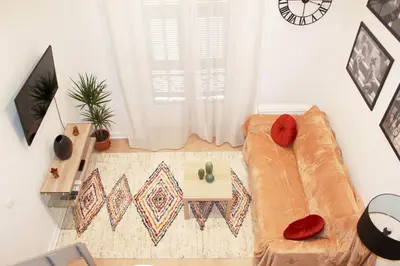 a living room with a couch and a table at Lofty - Massena sq - 5 min walk Beach in Nice