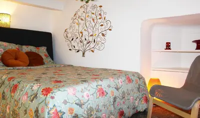 a bedroom with a bed and a chair in it at Lofty - Massena sq - 5 min walk Beach in Nice