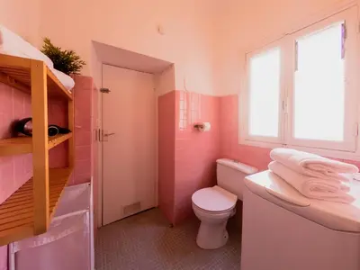 a pink bathroom with a toilet and a sink at Old Town- 4 Pers, Vieux Nice, AC, wifi in Nice