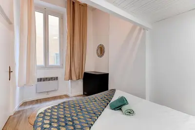 a bathroom with a sink and a washer and dryer at Vieille Ville - 5 pers, AC, WIFI in Nice